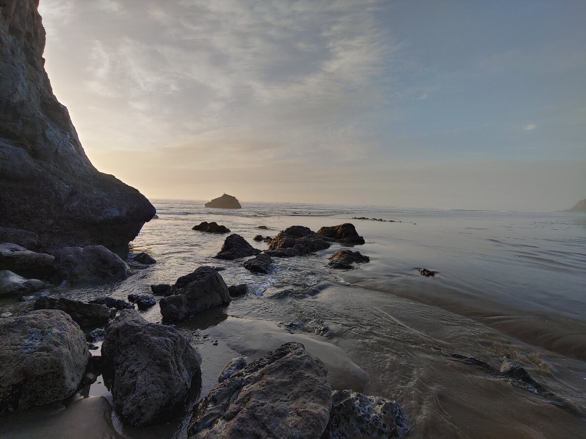 Rocky beach with tide pools and a sea stack at sunset on the Oregon coast