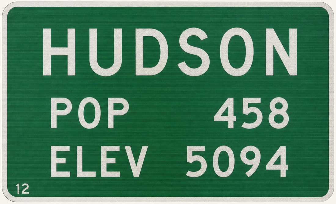 Green highway sign reading HUDSON, POP 458, ELEV 5094.