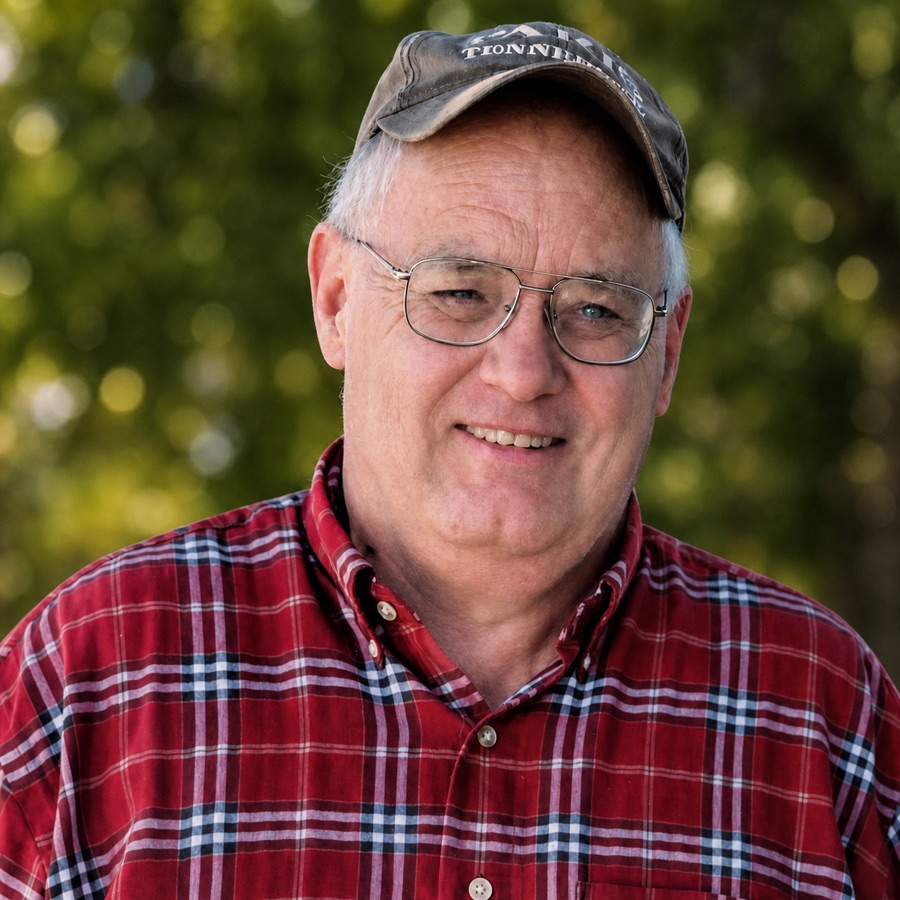 Mike Anderson in a red plaid shirt and ball cap